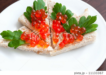 Tartlets with caviar and parsley on a plate Tartlets with caviar and parsley on a plate 11133367