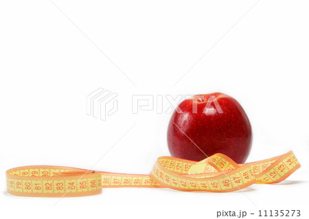 Red apple and measuring tape on a white background. Red apple and measuring tape on a white background. 11135273