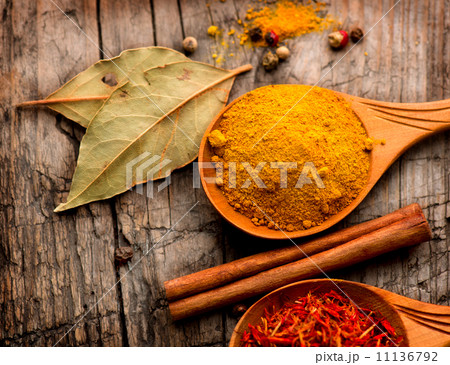 Spices and herbs. Curry, saffron, turmeric, cinnamon over wood 11136792