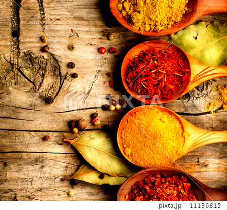Spices and herbs. Curry, saffron, turmeric, cinnamon over wood 11136815