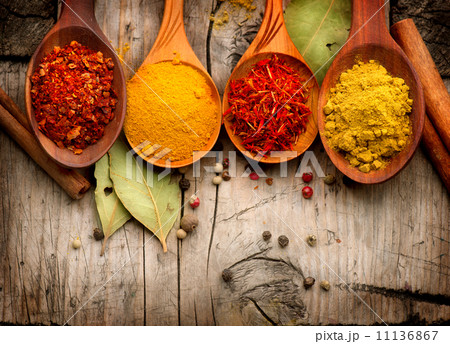 Spices and herbs. Curry, saffron, turmeric, cinnamon over wood Spices and herbs. Curry, saffron, turmeric, cinnamon over wood 11136867