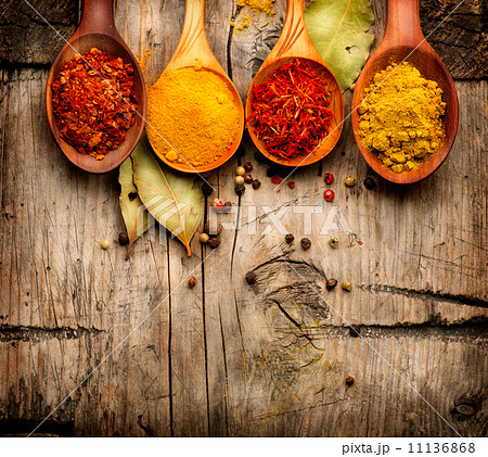 Spices and herbs. Curry, saffron, turmeric, cinnamon over wood Spices and herbs. Curry, saffron, turmeric, cinnamon over wood 11136868