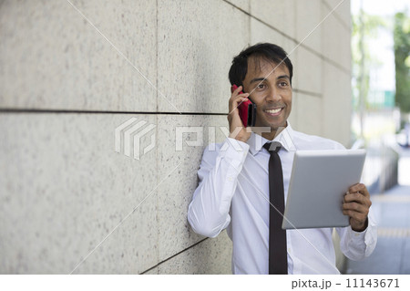 Indian man with a tablet computer. 11143671