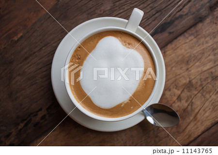 a cup of cappucino on wooden table 11143765