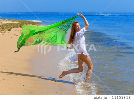 The young beautiful woman on an ocean coast. Indonesia. Bali... 11155318