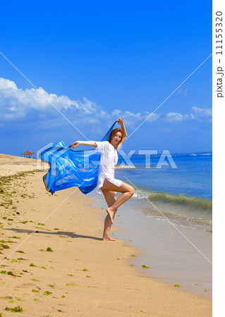 The young beautiful woman on an ocean coast. Indonesia. Bali... 11155320
