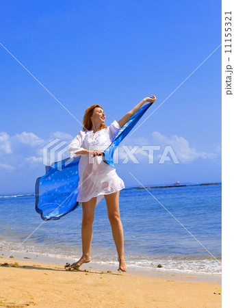 The young beautiful woman on an ocean coast. Indonesia. Bali... 11155321