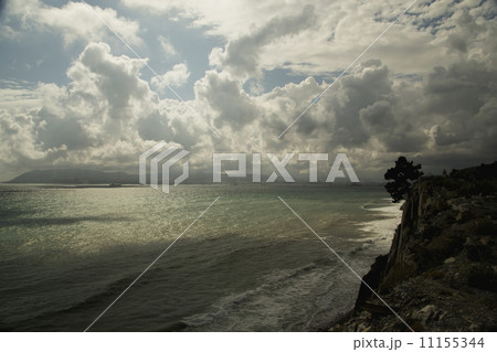 Seascape with a rocky shore, with blue sky and clouds 11155344
