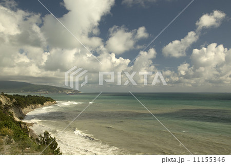 Seascape with a rocky shore, with blue sky and clouds Seascape with a rocky shore, with blue sky and clouds 11155346