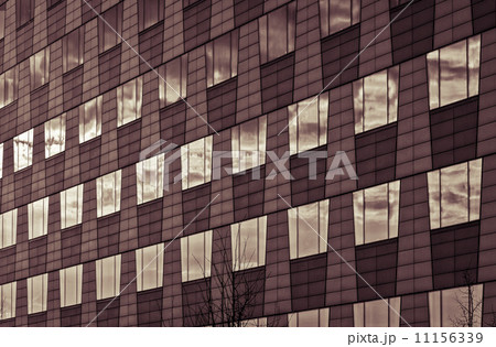 windows of a business house mirroring the sky, vintage color fil 11156339