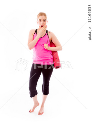 Young woman carrying exercising mat looking shocked 11166658