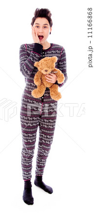 Young woman standing with her teddy bear and looking shocked Young woman standing with her teddy bear and looking shocked 11166868