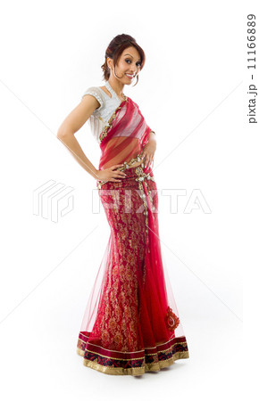 Young Indian woman standing with her arms akimbo 11166889