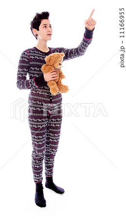 Young woman pointing and holding her teddy bear Young woman pointing and holding her teddy bear 11166955