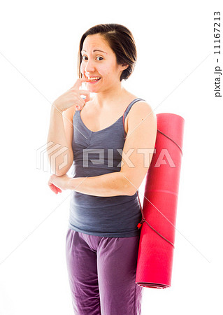 Young woman carrying exercise mat biting nail Young woman carrying exercise mat biting nail 11167213