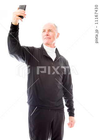 Senior man photographing himself with his mobile phone Senior man photographing himself with his mobile phone 11167430