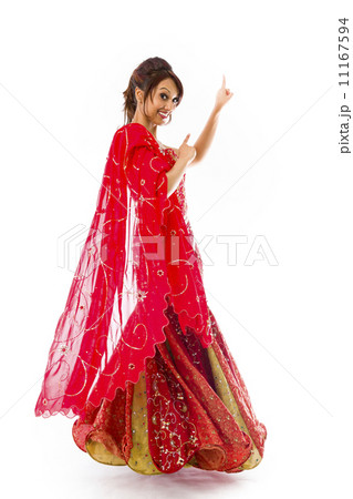 Young Indian woman pointing upward and smiling Young Indian woman pointing upward and smiling 11167594