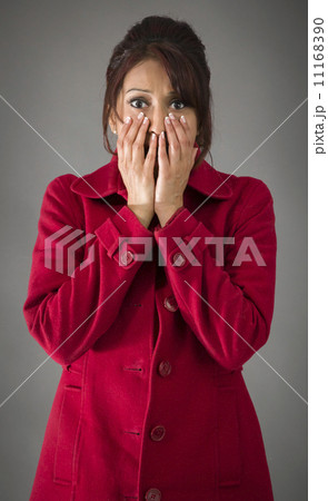 Shocked Indian woman with hand over mouth isolated on colored background Shocked Indian woman with hand over mouth isolated on colored background 11168390