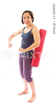 Young woman carrying exercise mat showing off her muscle 11169069