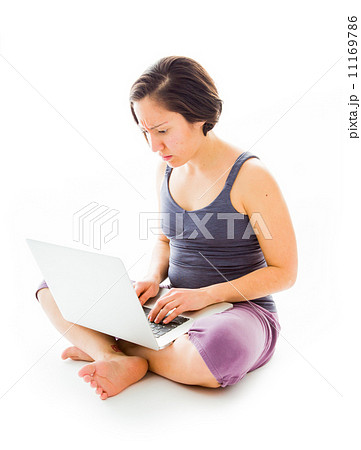 Young woman sitting on floor using laptop Young woman sitting on floor using laptop 11169786