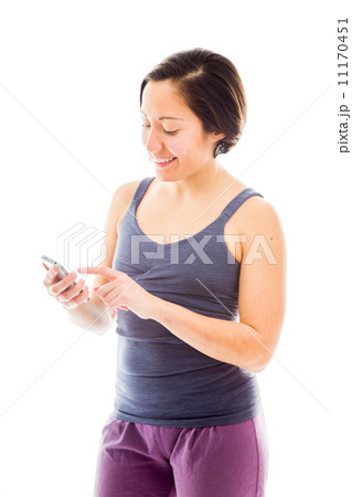 Young woman text messaging on mobile phone 11170451