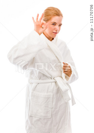 Young woman standing in bathrobe and showing ok sign 11170706