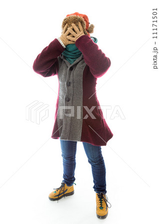 Young woman in warm clothing and covering her face with her hand Young woman in warm clothing and covering her face with her hand 11171501