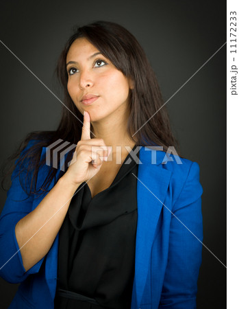 Thoughtful young businesswoman looking up with her finger on chin Thoughtful young businesswoman looking up with her finger on chin 11172233