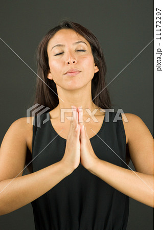 Young woman in prayer position and meditating Young woman in prayer position and meditating 11172297