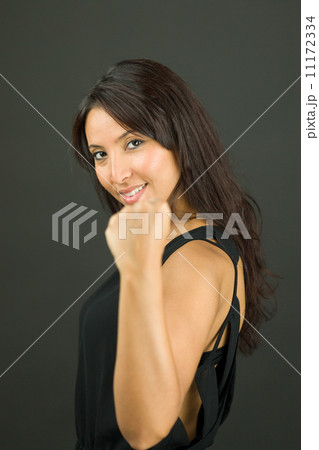 Excited young woman showing fist and celebrating success 11172334