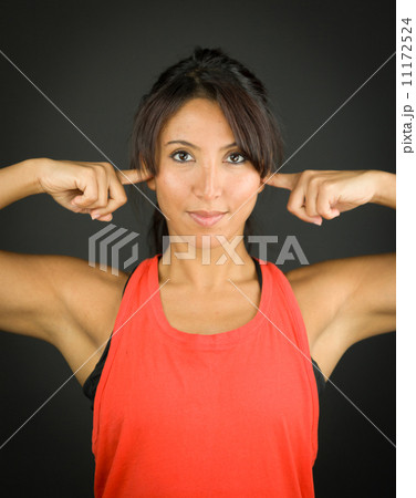 Portrait of a young woman closing her ears with her fingers Portrait of a young woman closing her ears with her fingers 11172524