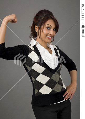 Indian businesswoman flexing biceps and smiling 11172790