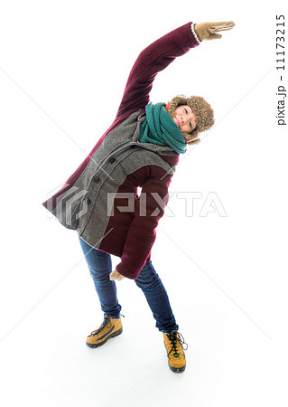 Young woman in warm clothing and stretching 11173215