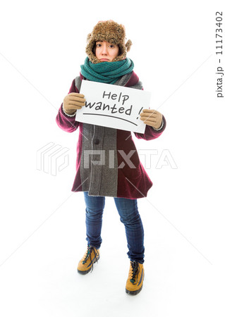 Young woman in warm clothing and showing help sign on white back Young woman in warm clothing and showing help sign on white back 11173402