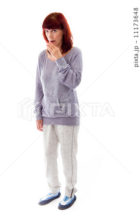Mature woman with hand over her mouth and shock 11173648