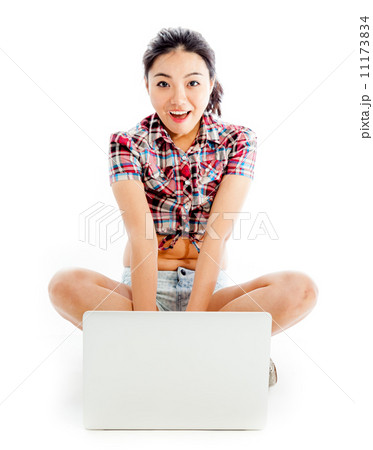 Isolated on white sexy asian cowgirl typing on computer 11173834