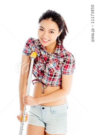 Isolated on white sexy asian cowgirl injured with a crutch 11173850