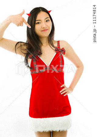 Devil side of a young Asian woman pointing and smiling isolated on white background 11174814