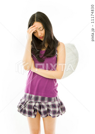 Upset Asian young woman dressed up as an angel with her head in hands isolated on white background Upset Asian young woman dressed up as an angel with her head in hands isolated on white background 11174830