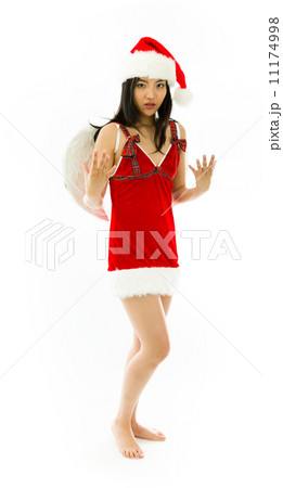 Asian young woman wearing Santa costume dressed up as an angel gesturing isolated on white background 11174998