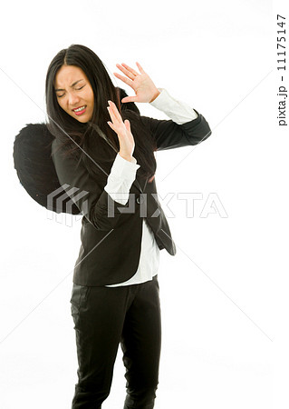 Afraid Asian young businesswoman dressed up as black angel say s Afraid Asian young businesswoman dressed up as black angel say s 11175147