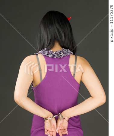 Rear view of devil side of a young Asian woman with handcuffs 11175279