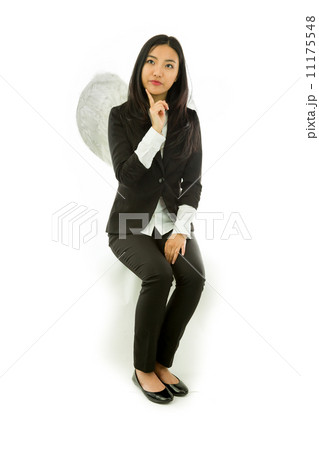 Asian young businesswoman sitting on stool dressed up as an angel looking up with finger on chin isolated on white background Asian young businesswoman sitting on stool dressed up as an angel looking up with finger on chin isolated on white background 11175548