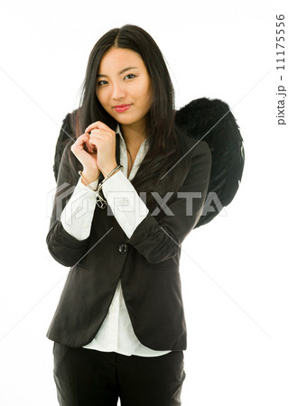 Asian young businesswoman dressed up as black angel handcuffs is Asian young businesswoman dressed up as black angel handcuffs is 11175556