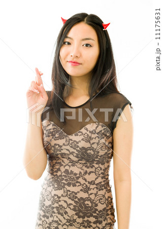 Asian young woman dressed up as a devil and showing her fingers crossed isolated on white background 11175631