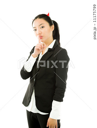 Devil side of a young Asian businesswoman standing with finger on lips asking for silence isolated on white background 11175799