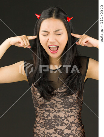 Young woman pretending to be a devil shouting in frustration Young woman pretending to be a devil shouting in frustration 11175855