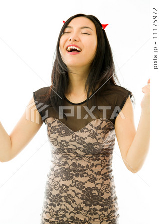 Asian young woman dressed up as a devil celebrating her success with fist up isolated on white background Asian young woman dressed up as a devil celebrating her success with fist up isolated on white background 11175972