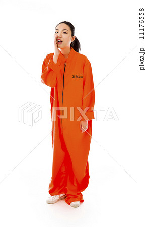 Young Asian woman whispering in prisoners uniform 11176558