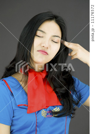 Asian air stewardess pointing finger to head 11176572